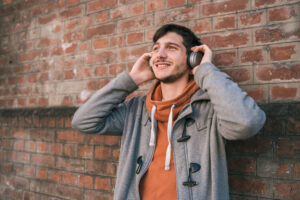 Latin man listening to music with earphones.